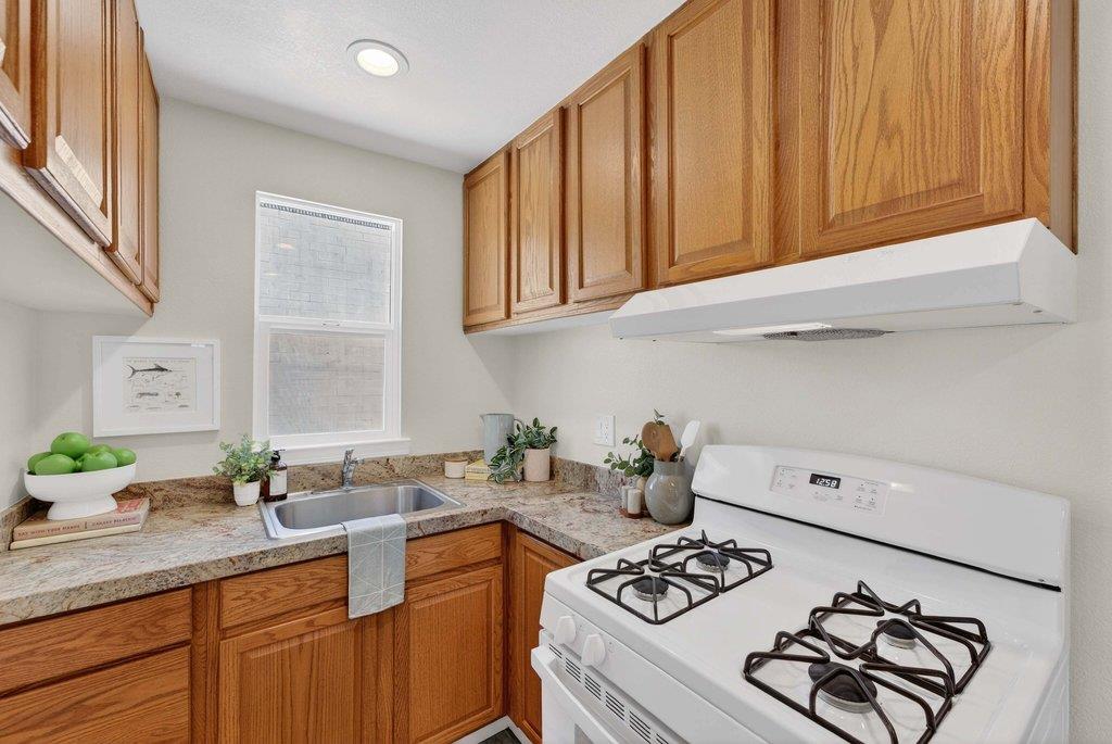152 Grove Street Watsonville, CA 95076 - Photo 13 of 35 a kitchen with stainless steel appliances granite countertop a sink stove and cabinets