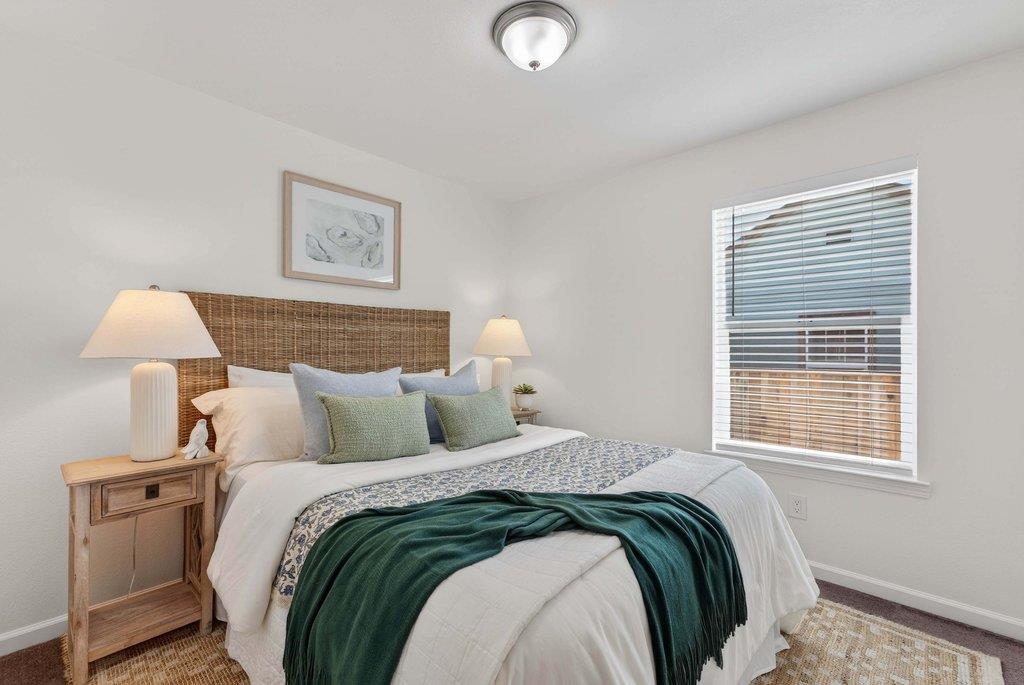 152 Grove Street Watsonville, CA 95076 - Photo 19 of 35 a bedroom with a bed and a lamp