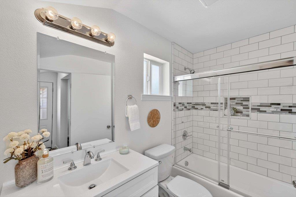 152 Grove Street Watsonville, CA 95076 - Photo 22 of 35 a bathroom with a sink mirror vanity and toilet
