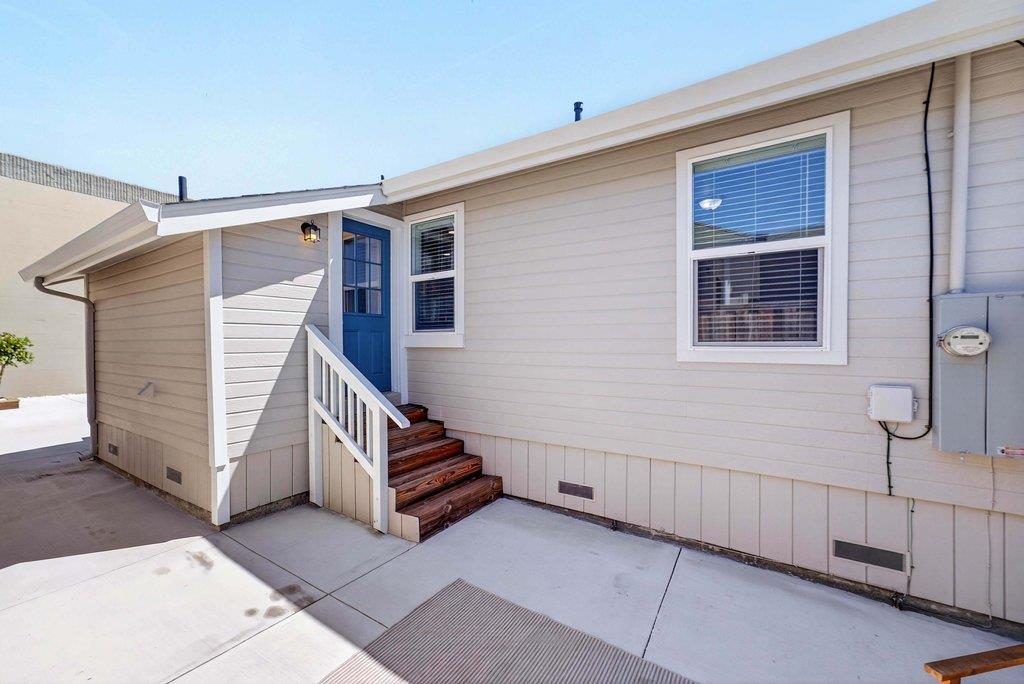 152 Grove Street Watsonville, CA 95076 - Photo 25 of 35 a view of a house with stairs and a small yard