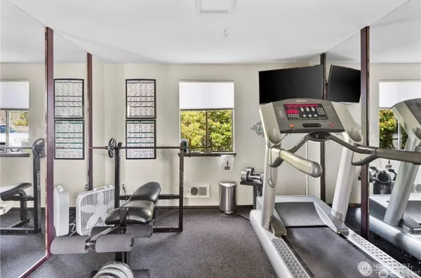 a living room with furniture a flat screen tv and a large window