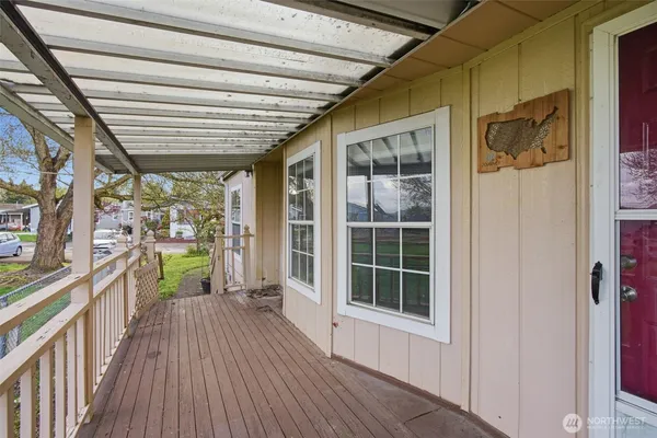 a view of a porch with wooden floor and iron stairs