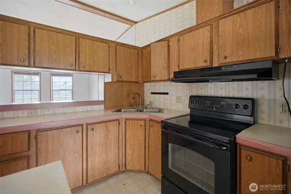 a kitchen with a stove and a microwave