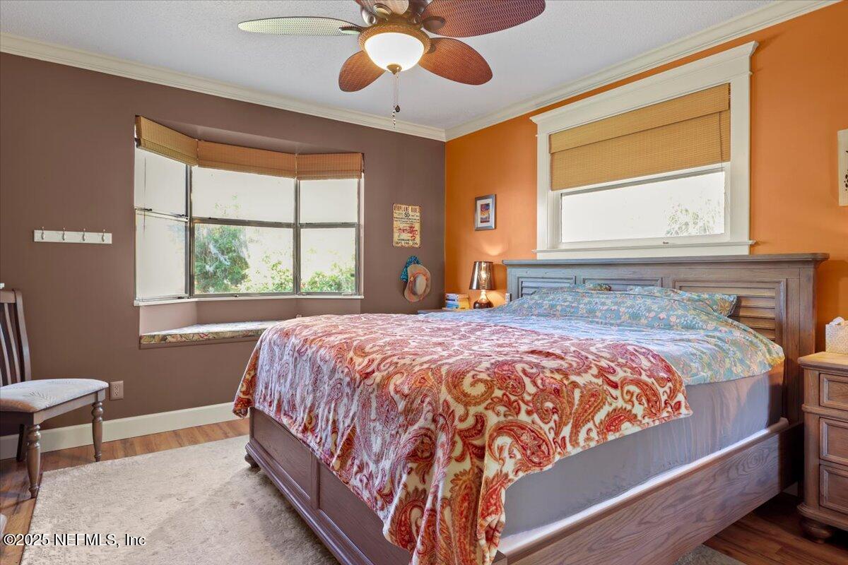 802 Lemon Avenue Crescent City, FL 32112 - Photo 13 of 46 a bedroom with a large bed and a chandelier