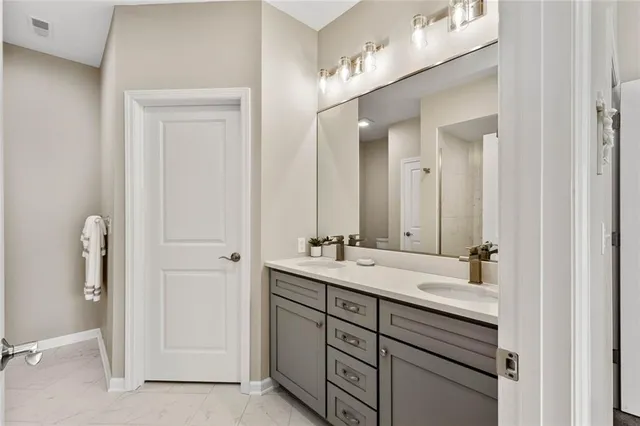 a bathroom with a double vanity sink and mirror