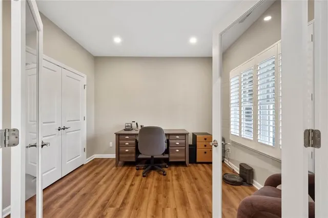 a view of a workspace with furniture and a window