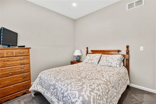 a bedroom with a bed and flat screen tv