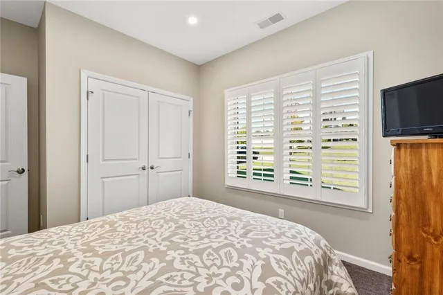 a bedroom with a bed and a large window