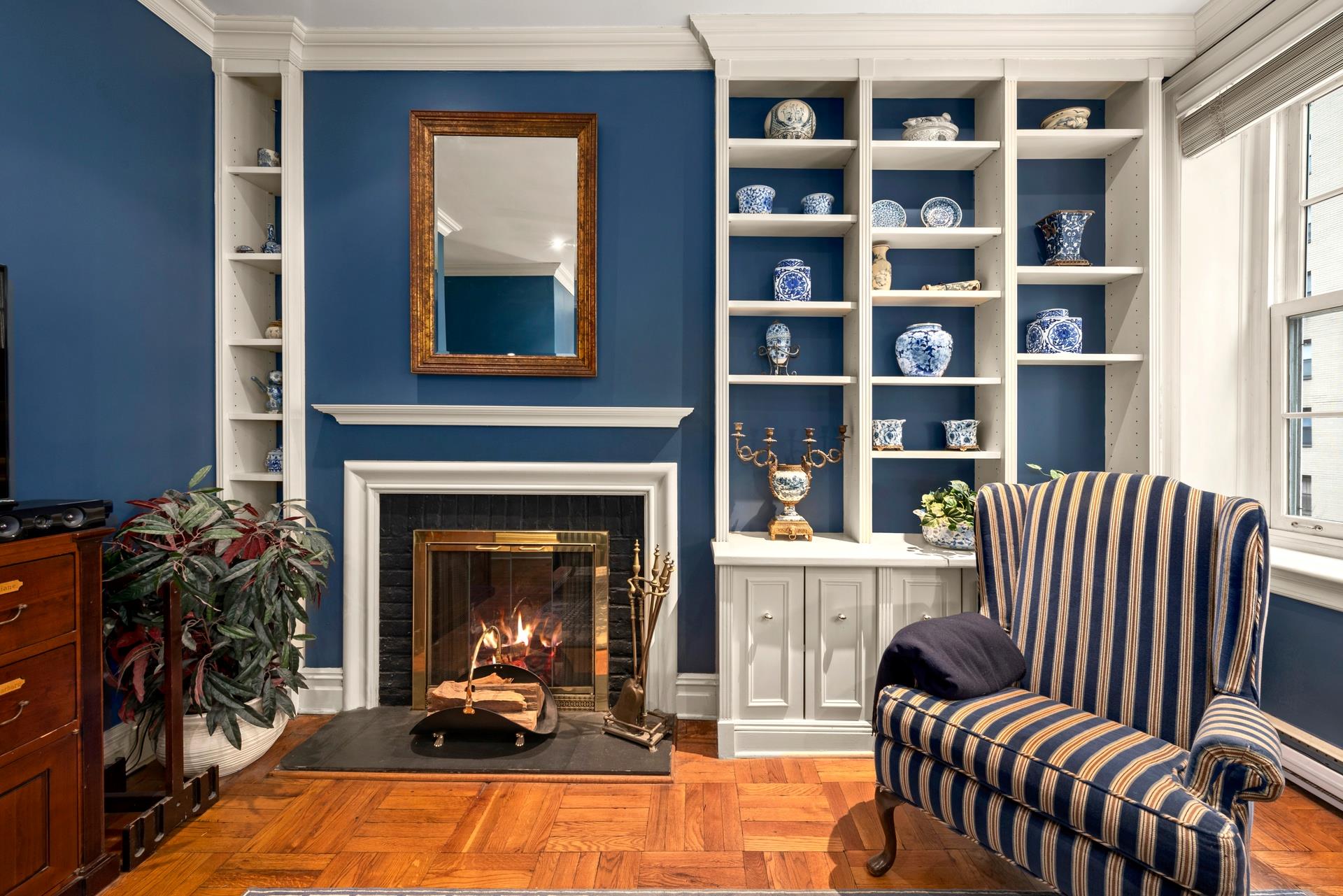 a living room with furniture fireplace and book shelf