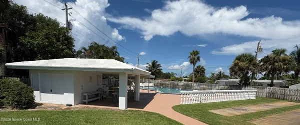 a view of a house with swimming pool and sitting area