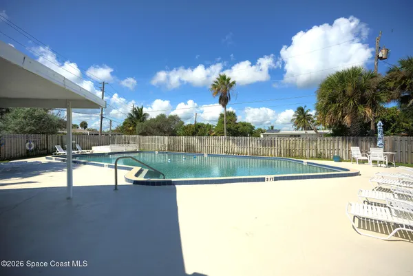 a view of a swimming pool with an outdoor seating