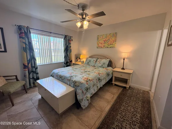 a bedroom with a bed couch and window