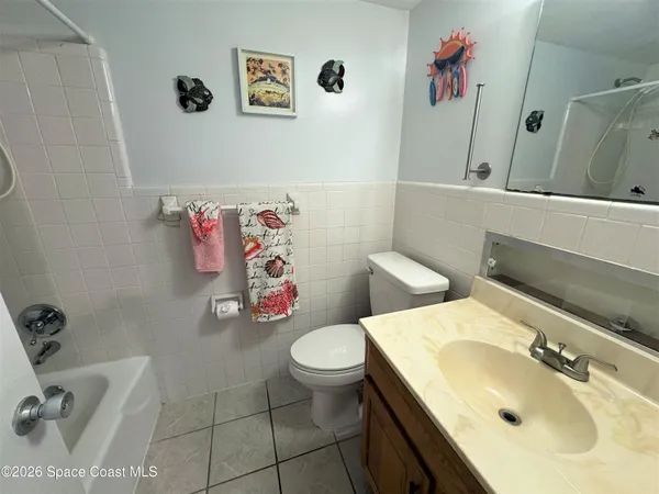 a bathroom with a sink mirror and toilet