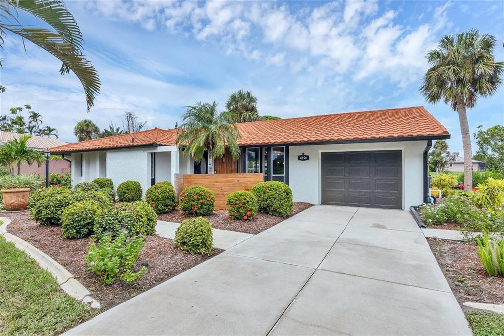 4696 Pompano Street Placida, FL 33946 - Photo 22 of 23 front view of a house with a yard and potted plants
