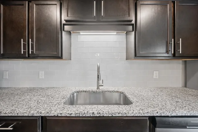 a kitchen with kitchen island a sink stainless steel appliances and a counter top