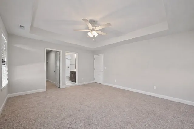 a view of an empty room with a ceiling fan