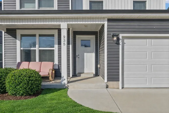 a front view of a house with a garden and plants