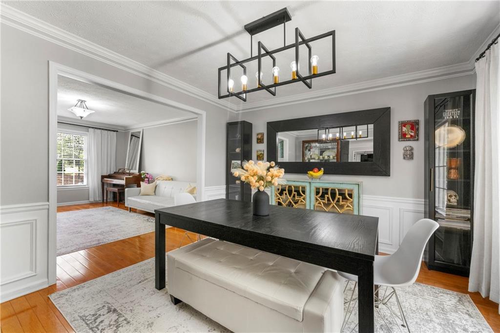 292 Old Rosser Road Stone Mountain, GA 30087 - Photo 12 of 66 a living room with furniture a chandelier and a flat screen tv
