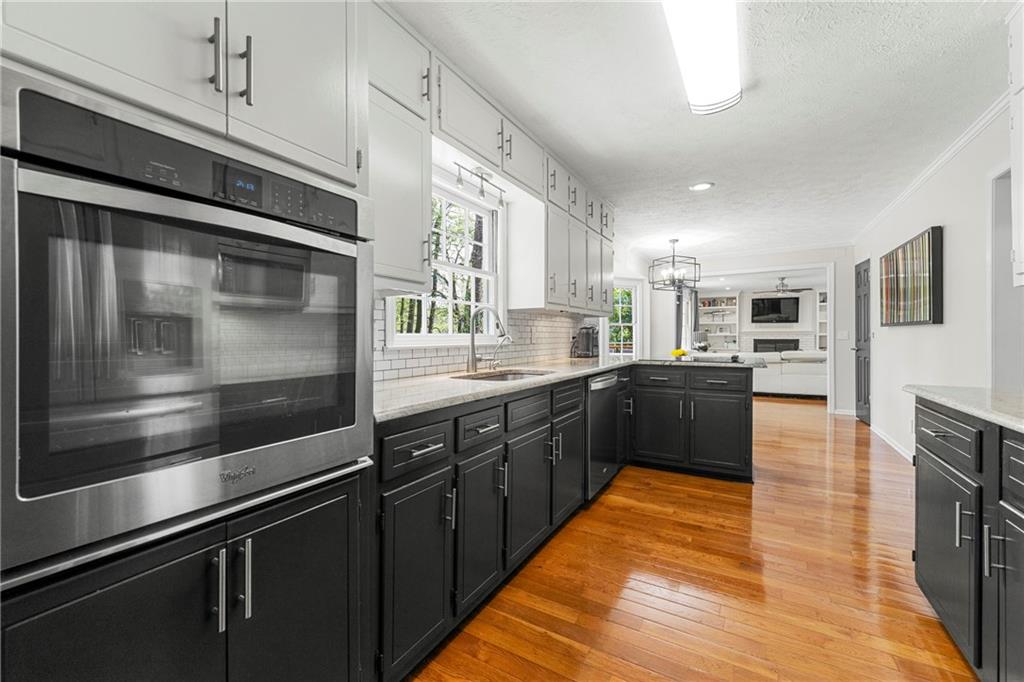 292 Old Rosser Road Stone Mountain, GA 30087 - Photo 14 of 66 a kitchen with stainless steel appliances kitchen island granite countertop a stove a sink and a microwave