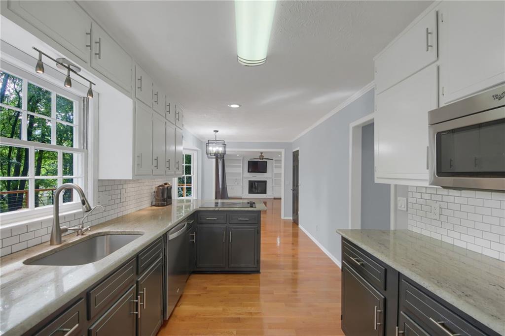 292 Old Rosser Road Stone Mountain, GA 30087 - Photo 17 of 66 a kitchen with granite countertop a sink and a stove top oven a granite counter space