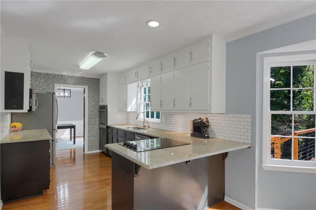 292 Old Rosser Road Stone Mountain, GA 30087 - Photo 19 of 66 a kitchen with a sink cabinets and window