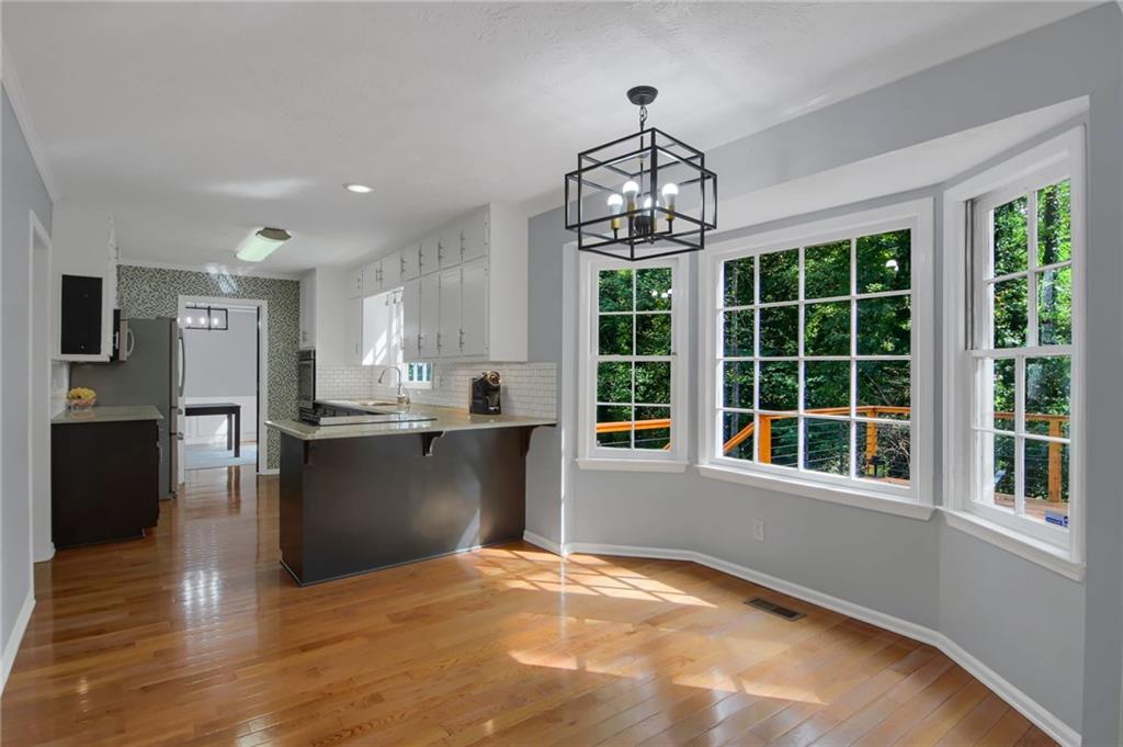 292 Old Rosser Road Stone Mountain, GA 30087 - Photo 20 of 66 a view of a kitchen with granite countertop stainless steel appliances and a chandelier