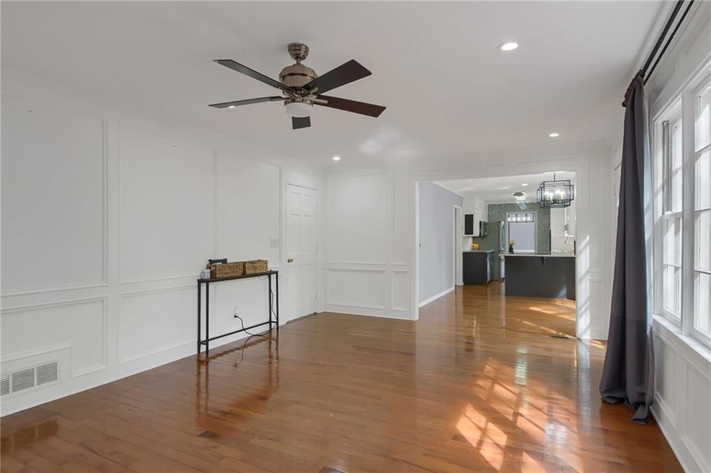 292 Old Rosser Road Stone Mountain, GA 30087 - Photo 27 of 66 a view of a livingroom with a hardwood floor and a ceiling fan