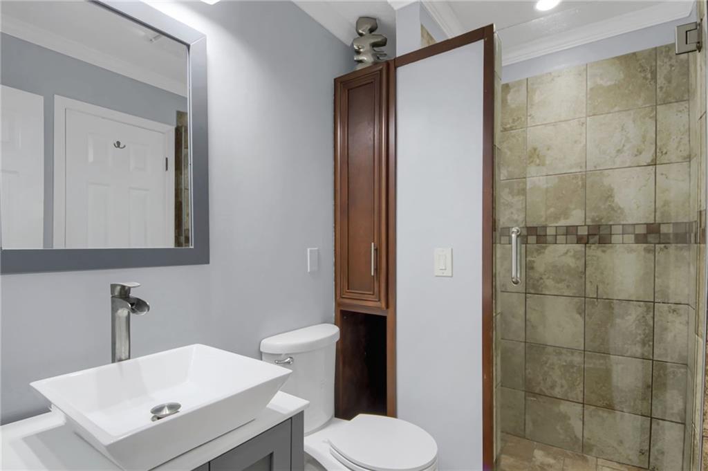 292 Old Rosser Road Stone Mountain, GA 30087 - Photo 28 of 66 a bathroom with a sink toilet and shower