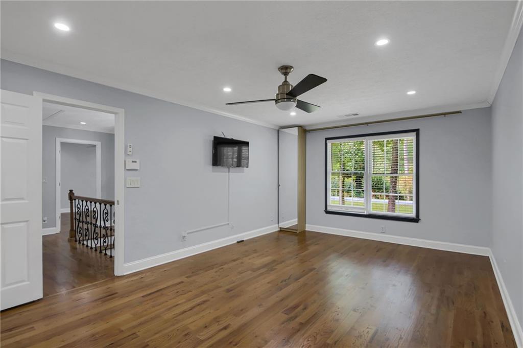 292 Old Rosser Road Stone Mountain, GA 30087 - Photo 34 of 66 a view of an empty room with wooden floor and a window