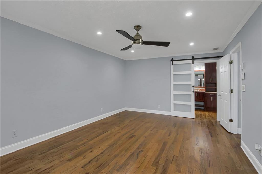 292 Old Rosser Road Stone Mountain, GA 30087 - Photo 36 of 66 a view of empty room with wooden floor and kitchen view