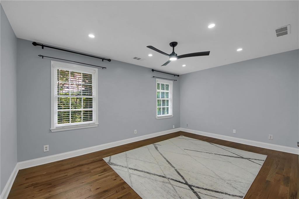 292 Old Rosser Road Stone Mountain, GA 30087 - Photo 43 of 66 a view of an empty room with a window and a ceiling fan