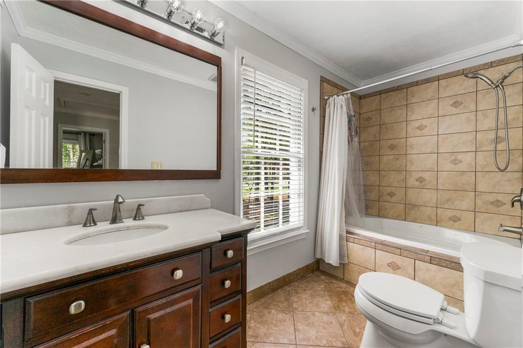 292 Old Rosser Road Stone Mountain, GA 30087 - Photo 44 of 66 a bathroom with a sink a toilet a mirror and shower