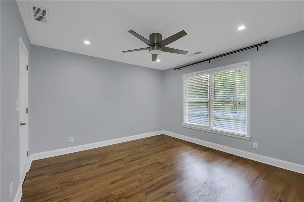 292 Old Rosser Road Stone Mountain, GA 30087 - Photo 47 of 66 wooden floor in an empty room with a window