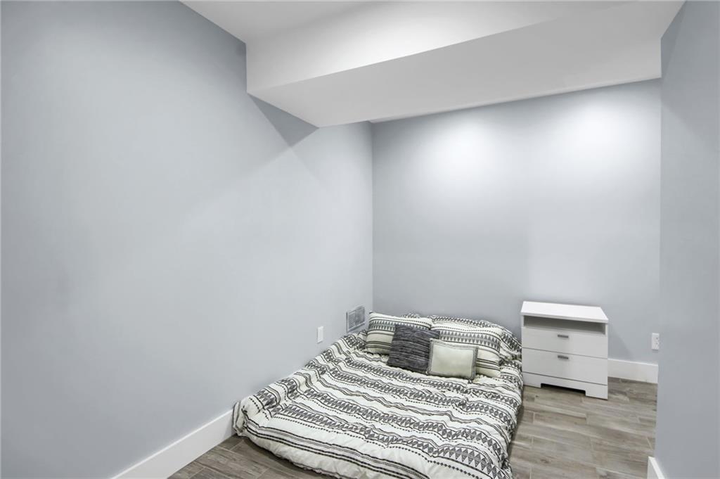 292 Old Rosser Road Stone Mountain, GA 30087 - Photo 49 of 66 a bedroom with a bed and a night stand