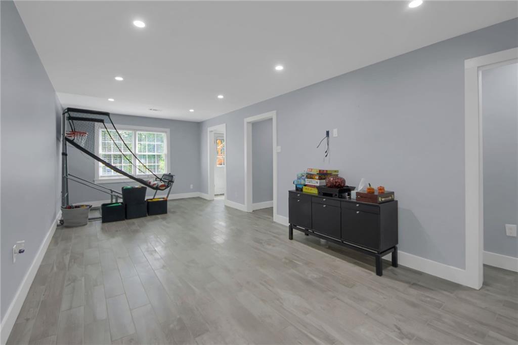 292 Old Rosser Road Stone Mountain, GA 30087 - Photo 52 of 66 a living room with furniture and a wooden floor