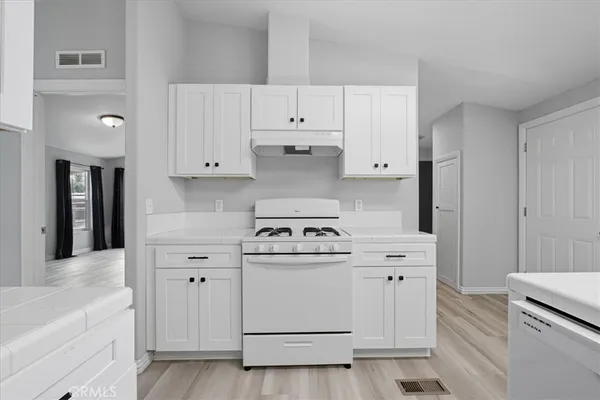 a view of a kitchen with a sink cabinet and a window