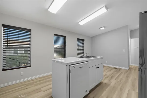 a kitchen with white cabinets and white appliances