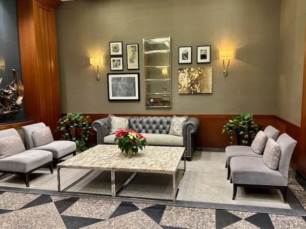 a living room with furniture and painting on the wall