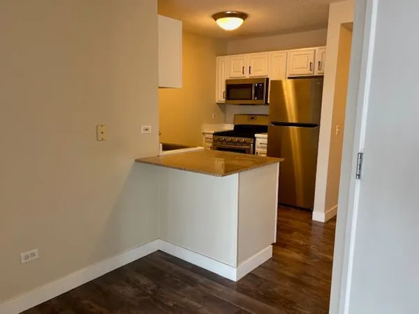 a kitchen with a refrigerator and a stove