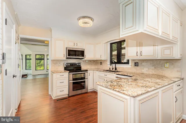 a living room with furniture and large windows