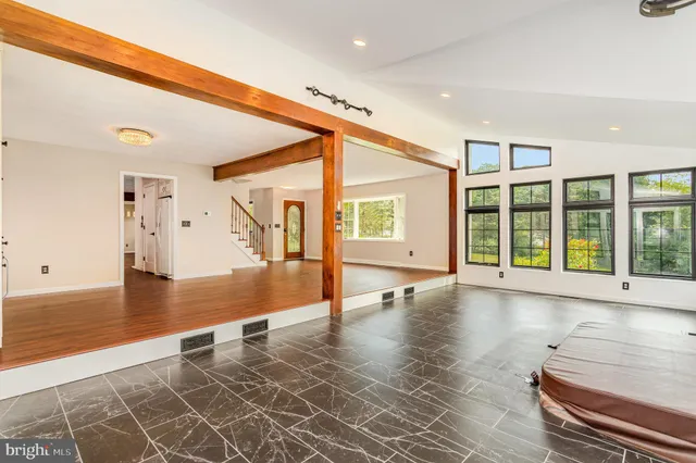 a view of an empty room with wooden floor