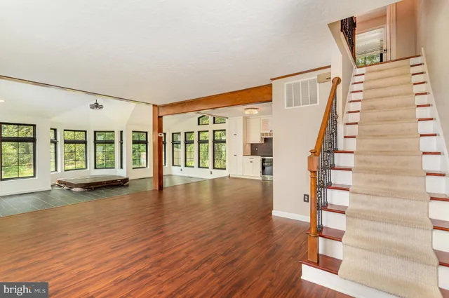 a large bathroom with a tub sink shower and mirror