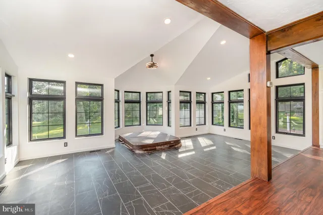 a view of an empty room with wooden floor