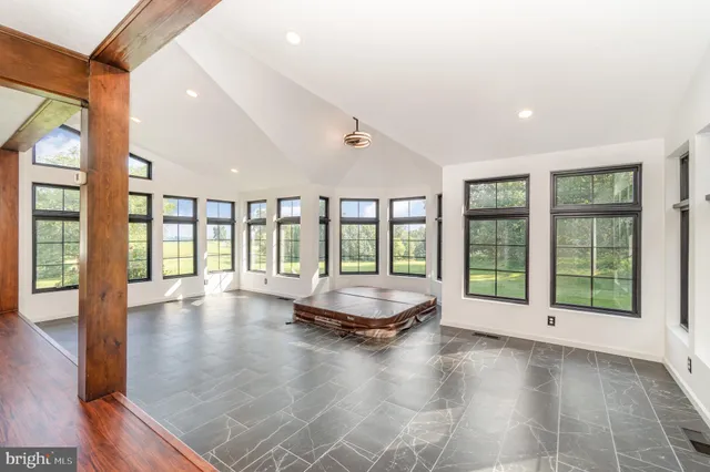 a bathroom with a granite countertop sink and a large mirror
