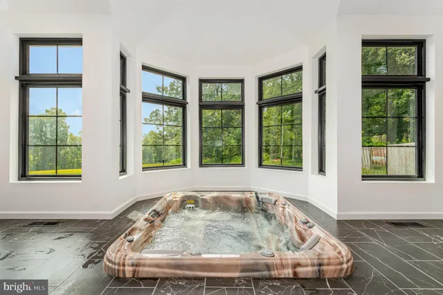 a view of a house with swimming pool and sitting area