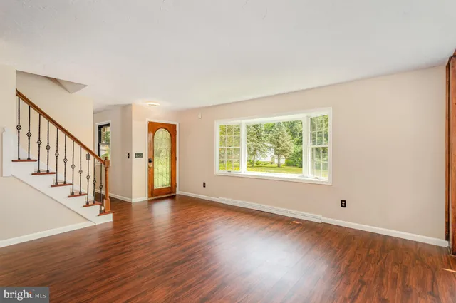 a living room with furniture a rug and a flat screen tv
