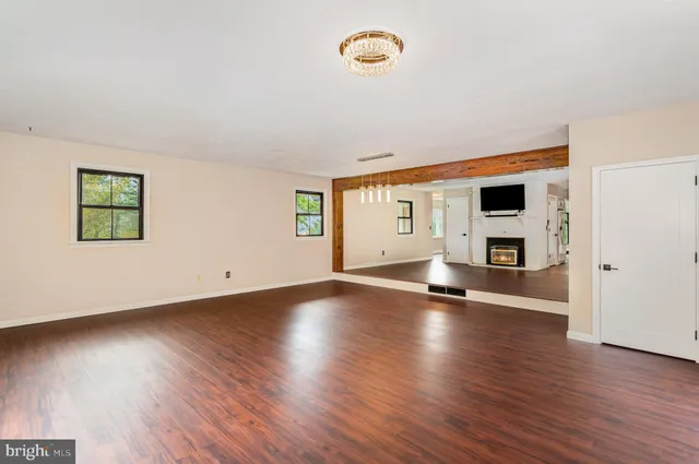 a view of a livingroom with wooden floor and window