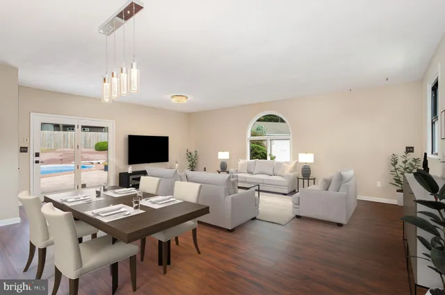 a view of a livingroom with a flat screen tv wooden floor and a fireplace