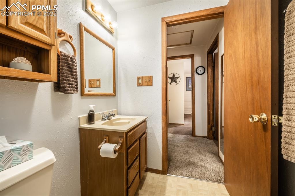 8181 Maple Drive Rye, CO 81069 - Photo 21 of 50 a bathroom with a sink a mirror and a toilet