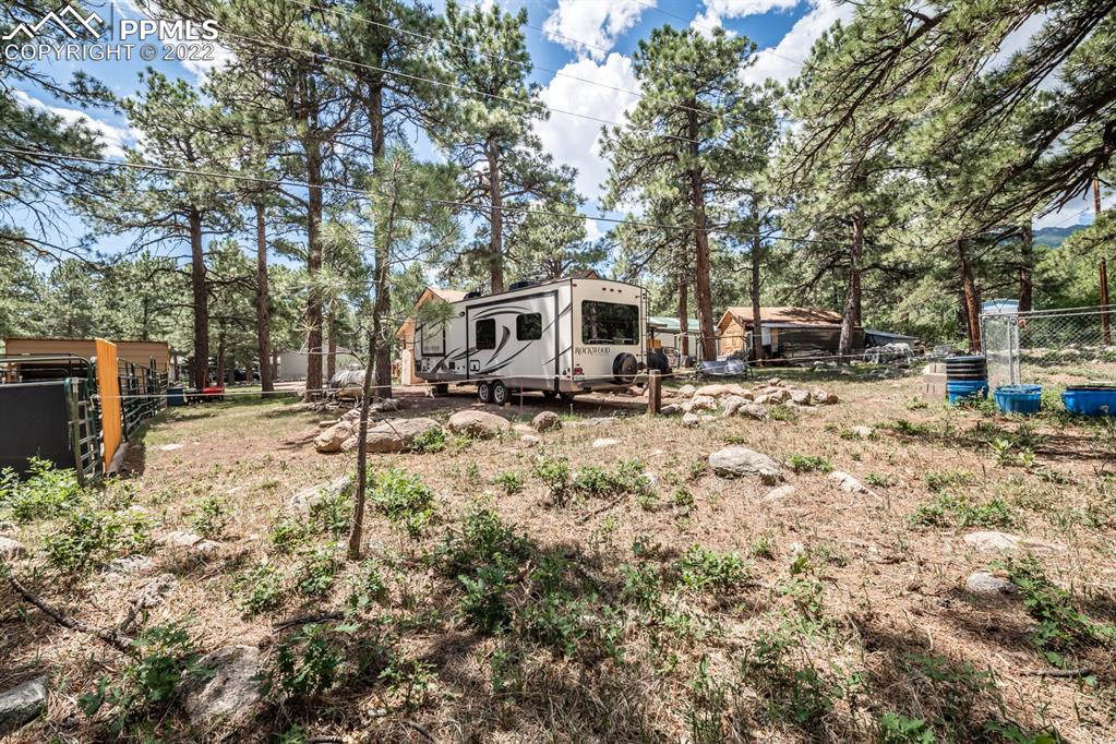 8181 Maple Drive Rye, CO 81069 - Photo 23 of 50 a backyard of a house with fire pit and trees